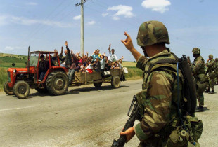 Refugjatët shqiptarë përshëndesin ushtarët amerikanë rrugës në Gjilan, 16 qershor 1999 (Foto: AP)